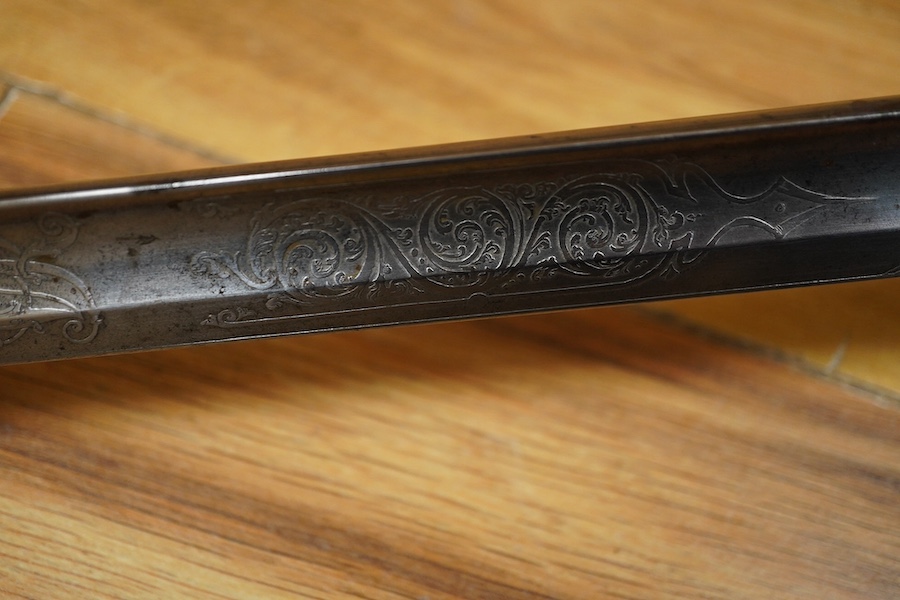 An 1845 pattern infantry officer’s sword by Henry Wilkinson, number 19387, regulation hilt, (fish skin covering missing), in its iron scabbard. Condition - fair to good.